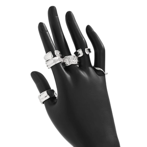 Detailed view of irregular liquid silver rings stacked on a black matte hand display