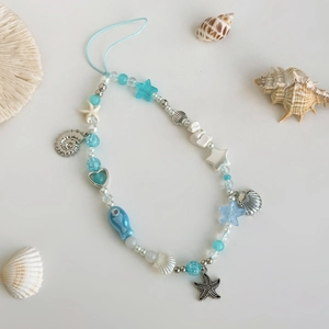 Marine theme phone charm with blue beads, sea stars, shells and ceramic fish ornaments