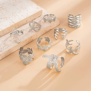 Detailed view of nine silver sea-themed rings featuring starfish and shell textures
