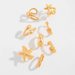 Detailed view of an 8-piece gold nautical ring set featuring starfish and shell designs