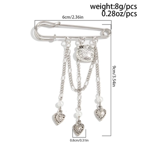 Detailed view of silver safety pin brooch with heart pendants and pearl chain dimensions