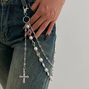 Detail of Y2K silver layered pants chain with colorful rhinestones and cross pendant