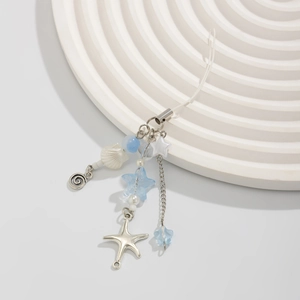 Detailed close-up of ocean-themed charm with silver starfish and blue crystal beads