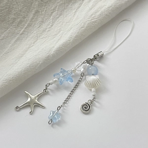 Detail of ocean-themed charm featuring starfish pendant and blue shell beads