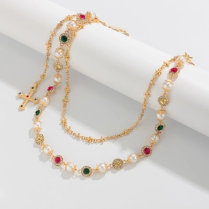 Detailed view of multilayer gold hip-hop waist chain with pearls and cross pendant