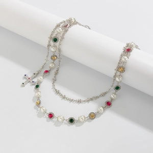 Close-up of multilayer punk pants chain with colorful stones and rhinestone cross