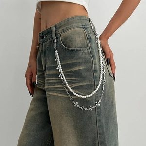 Détail d'une chaîne de taille double couche style punk avec perles et croix métalliques