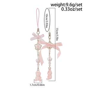 Detail of pink ribbon bow phone charms with star beads and cute gummy bear pendants