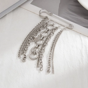 Detail of silver multi-layer tassel chain with star pin for punk style denim decoration