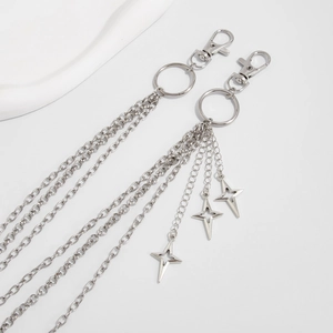 Detail of silver layered chain with lobster clasp and three hollow star pendants
