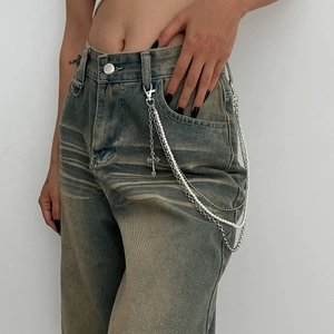 Détail de la chaîne de pantalon punk multicouche avec perles et pendentif croix