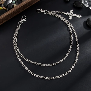 Detail of layered silver hip hop waist chain featuring a retro engraved cross pendant