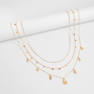 Detailed macro view of multi-layer golden waist chain with shells and pearls