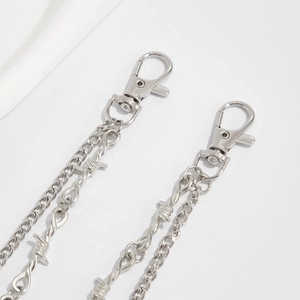Detail of silver layered hip-hop waist chain with lobster clasps and punk metal links