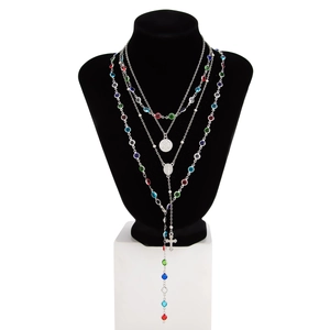 Dettaglio macro della collana a Y multistrato argento con pietre colorate e croce