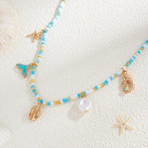 Detail of beach waist chain with starfish, conch, and turquoise fish tail charms