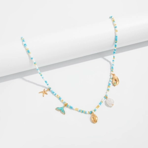Detail of ocean-themed beaded body chain with starfish, shell and dolphin tail charms