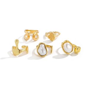 Detail of five-piece gold plated ring set featuring baroque pearls and wavy textures