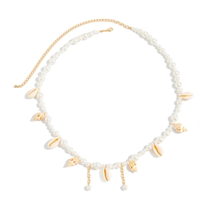 Detailed view of bohemian body chain with white pearls and diverse seashell charms