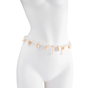 Detail of seashell pendants and imitation pearl fringe on a golden waist chain