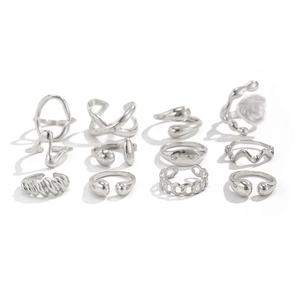 Macro view of 12-piece silver ring set with twist patterns and minimalist wavy designs