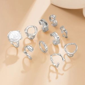 Artistic silver ring set with organic lava textures and a large baroque pearl