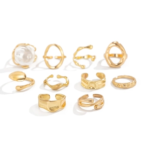 Detailed view of 10-piece gold ring set featuring baroque pearls and lava textures