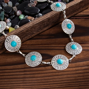 Detailed close-up of Bohemian metal waist chain with turquoise stones and floral engraving