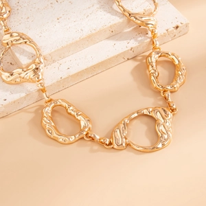 Minimalist golden geometric body chain with irregular metal links and hand-forged texture