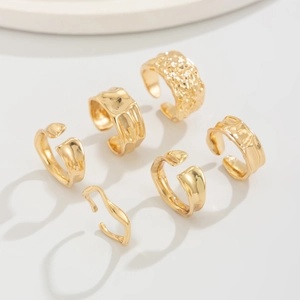 Set of 6 adjustable gold rings featuring hammered texture and irregular wave patterns