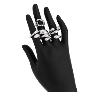 Close-up of silver liquid metal style rings on a black hand model with irregular texture
