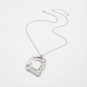 Close-up of irregular hollow square shell pendant necklace with silver textured finish