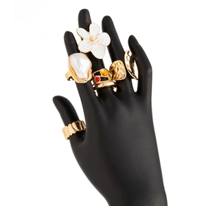 Vintage gold ring set with white flower, baroque pearl and gemstone on black hand model