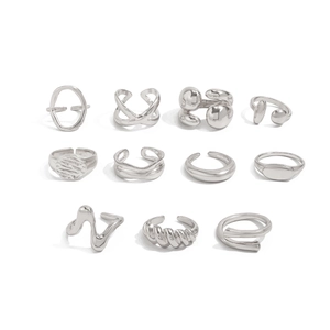 Detailed view of an 11-piece set of silver metallic rings with irregular lava-like textures