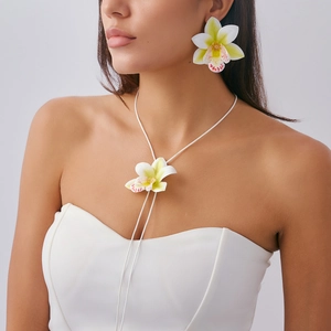 Realistic white orchid necklace and earring set on model in elegant bridal look