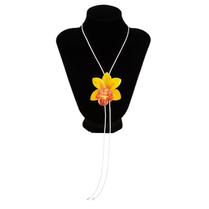 Detailed view of yellow and maroon orchid floral pendant on a thin white neck cord