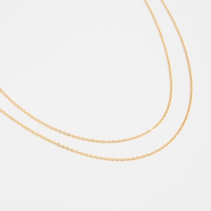 Detailed macro view of minimalist golden snake bone chain link texture and finish