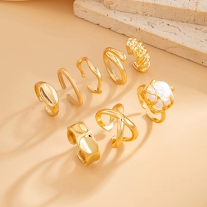 Detailed set of 8 gold stackable rings featuring faux pearl and textured geometric bands