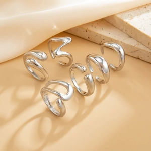 Macro view of S925 engraved stamp on minimalist liquid metal irregular silver rings