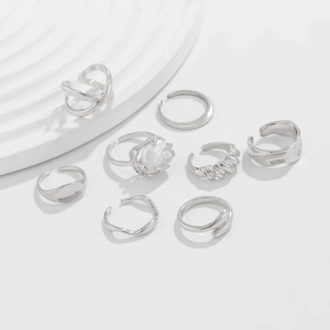 Detail of 8pcs silver ring set with pearls and geometric irregular designs on stone stand