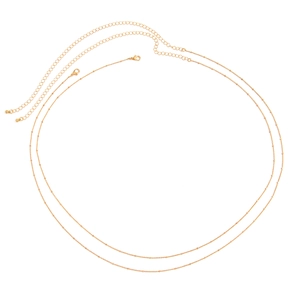 Detailed view of adjustable golden double-layer chain with lobster clasp and extension link