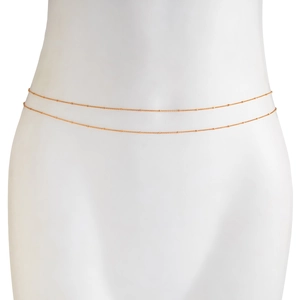Detail of a minimalist gold double-layered waist chain with small delicate beads