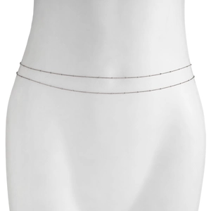 Detail of silver double-layered snake waist chain with delicate metal beads on white mannequin