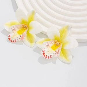Detailed macro view of orchid floral earrings with yellow and white gradient petals
