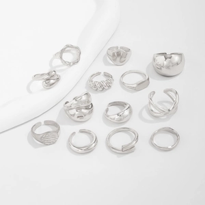Detail of 13-piece silver geometric ring set with smooth and twisted minimalist designs