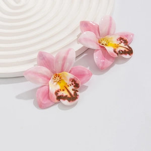 Detail view of pink orchid earrings with enamel gradient petals and golden center details