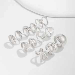 Flat lay of 11-piece silver adjustable rings set with minimalist and irregular geometries