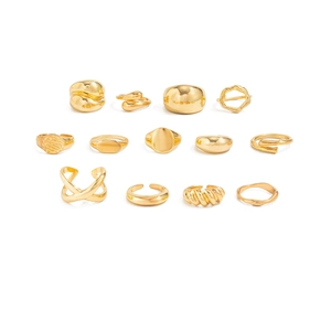 Detailed flat lay of 13 gold-plated rings and ear cuffs in various geometric styles