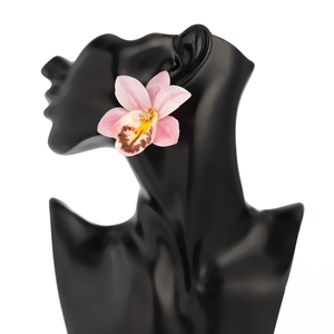 Detailed macro view of an orchid earring with realistic pink gradient resin petals