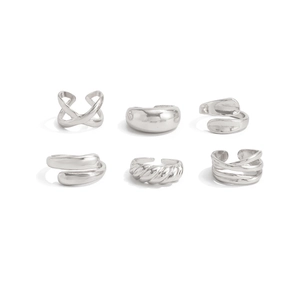Polished silver geometric ring set with teardrop and twisted textures on white background